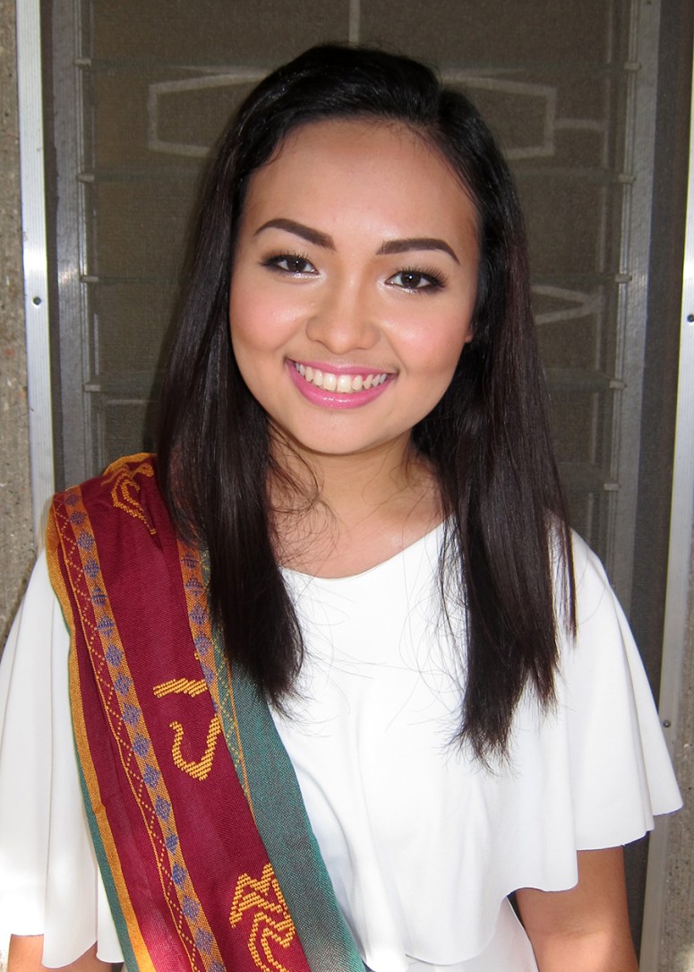 another photo of her wearing her graduation outfit