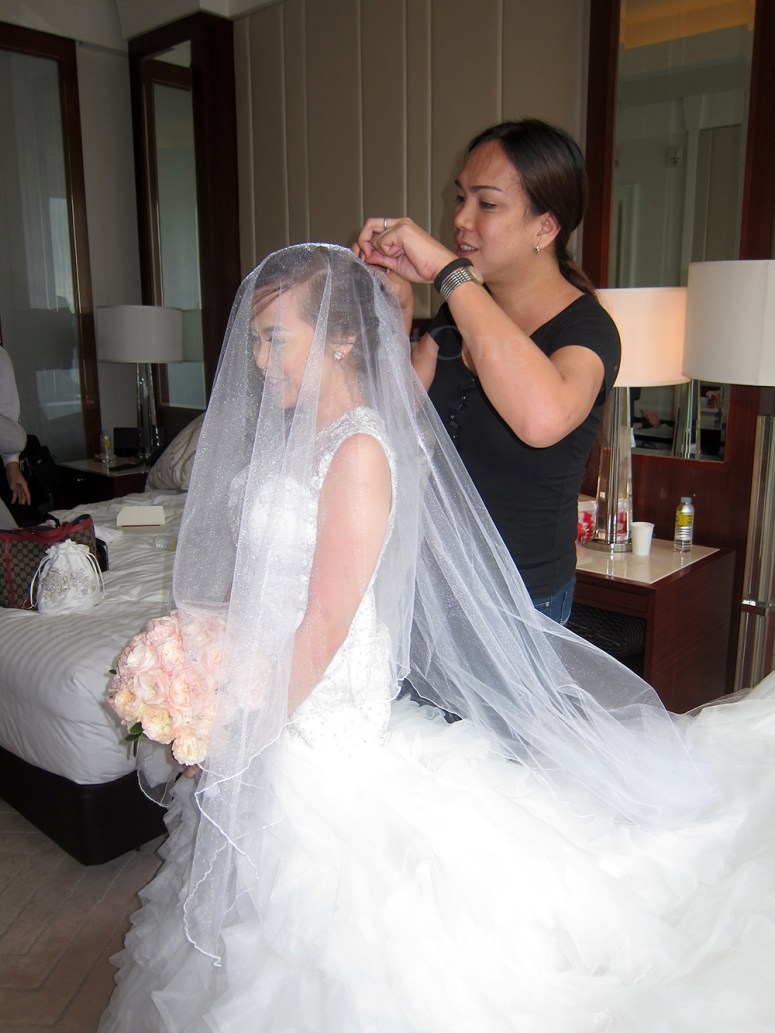 Wheng putting the veil on the bride!